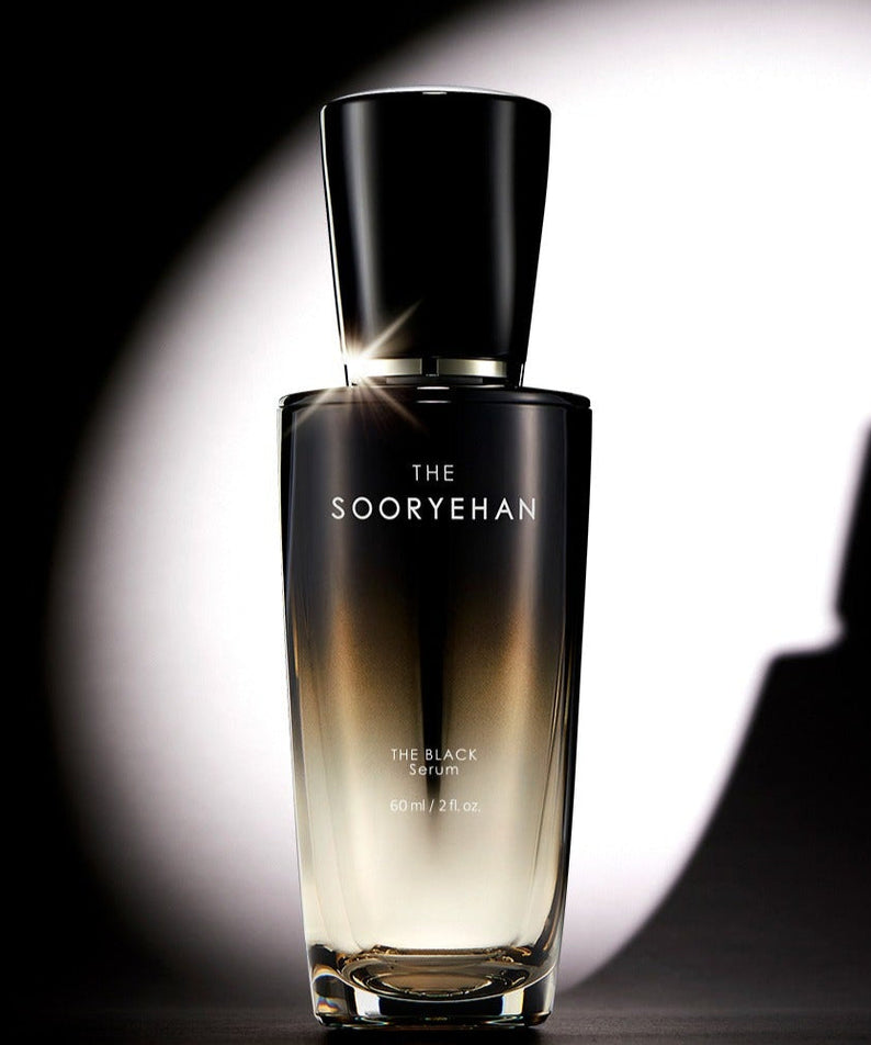 SOORYEHAN The Black Serum 30ml bottle on a reflective surface with dramatic lighting.