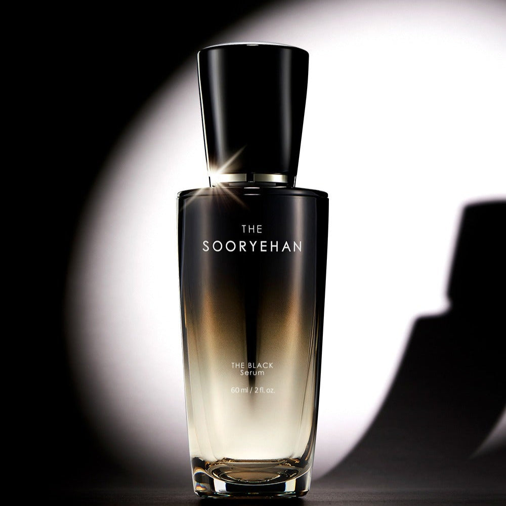 SOORYEHAN The Black Serum 30ml bottle on a reflective surface with dramatic lighting.