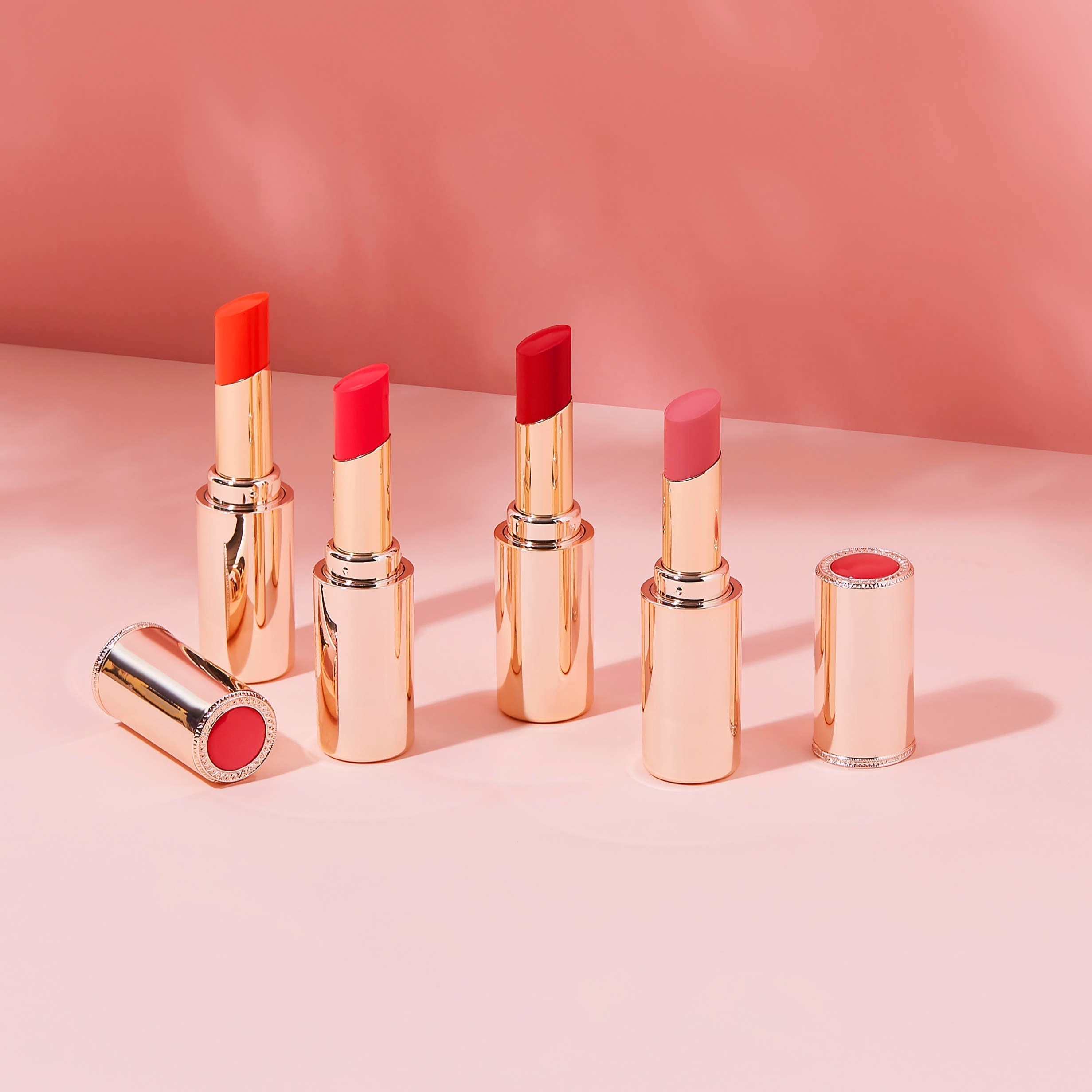 Four shades of SOORYEHAN Yeon Silk Lip Rough 3.5g lipsticks against a pink backdrop.
