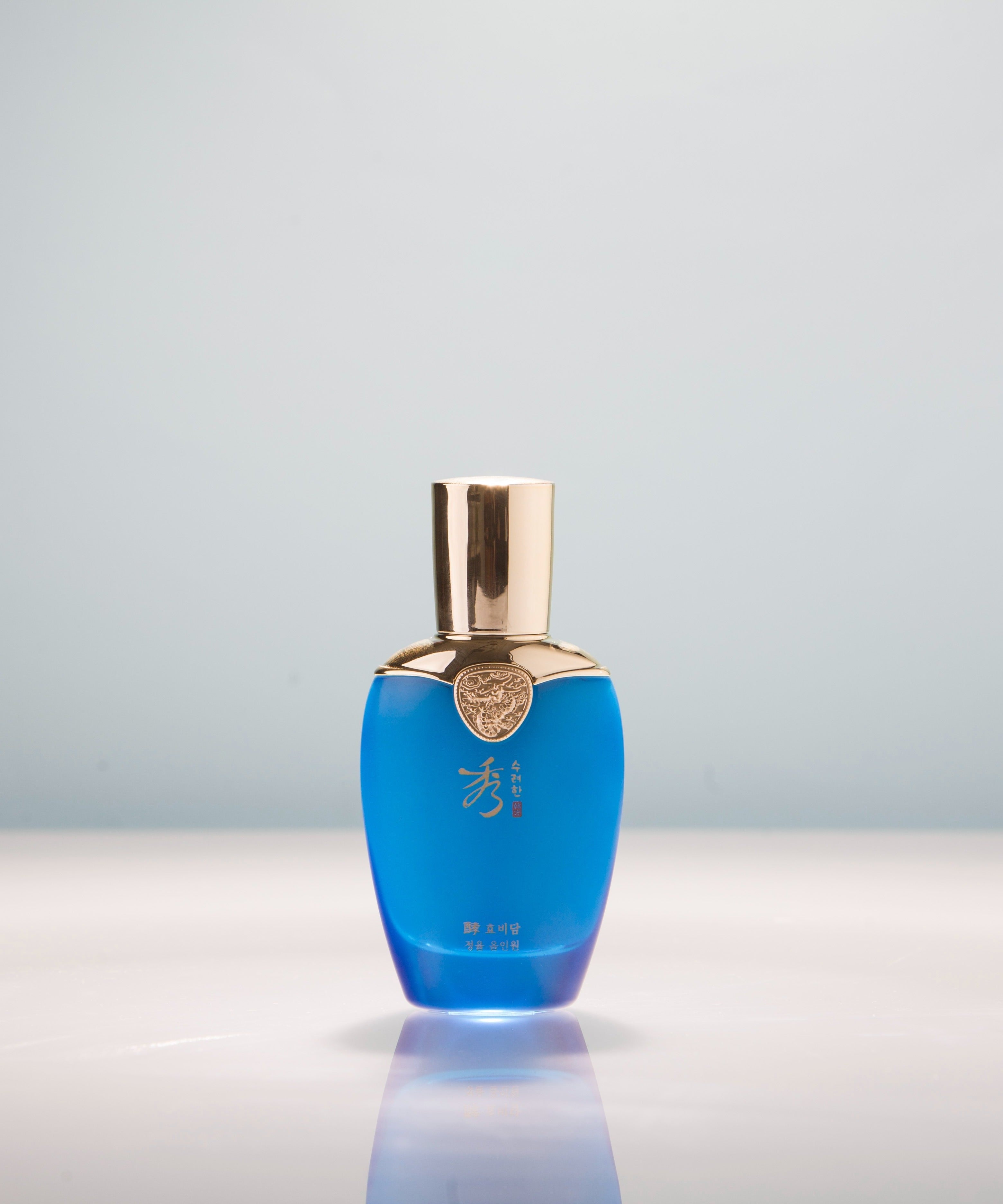 SOORYEHAN Hyobidam Jeongyul All-in-One 100ml blue bottle on a reflective surface.