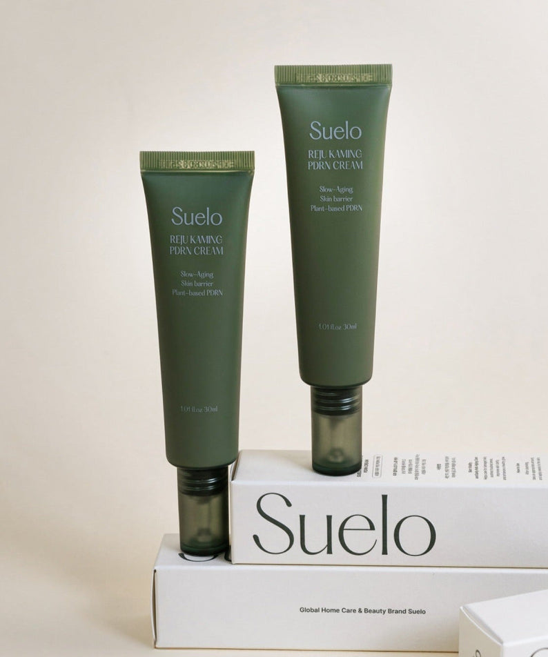 SUELO Reju Calming PDRN Cream 30ml with packaging, skin-soothing formula, two tubes displayed elegantly on beige background