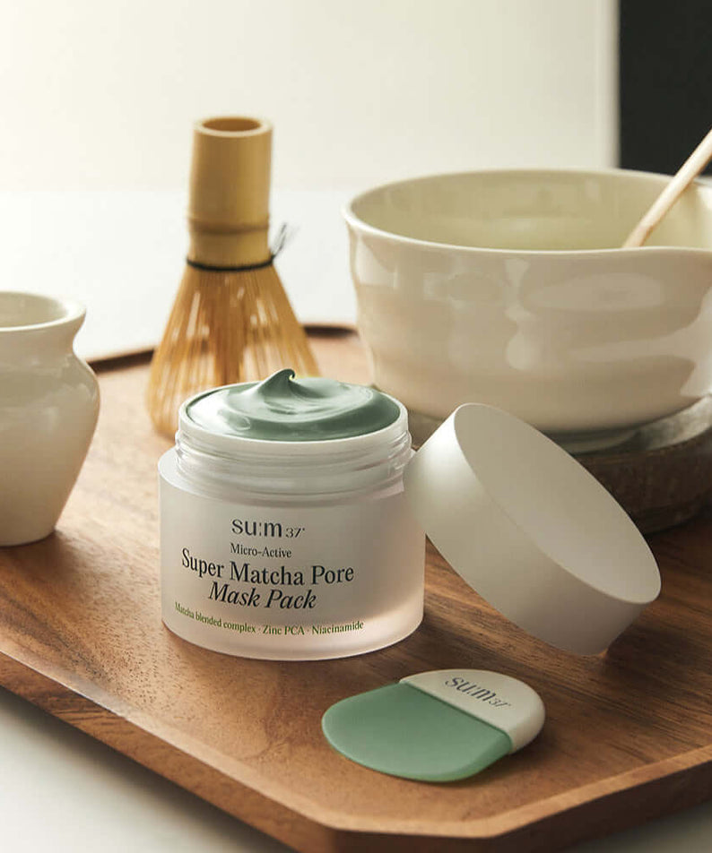 SU:M37 Microactive Super Matcha Pore Mask 100ml displayed on wooden tray with traditional matcha tools.