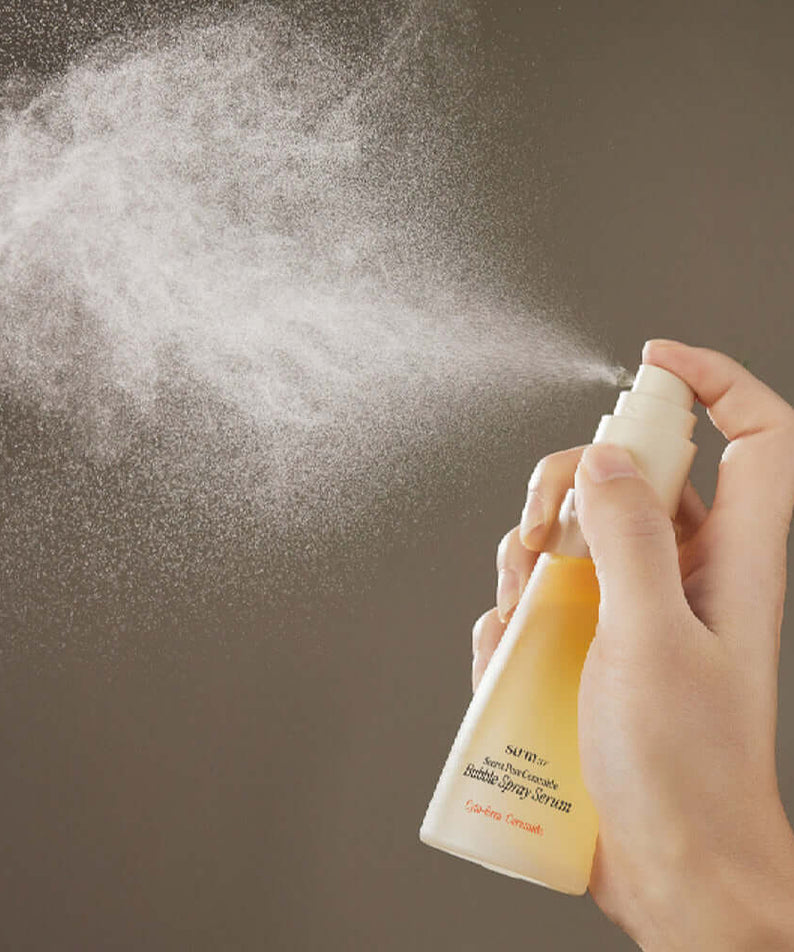Person spraying SU:M37 Secret Pore Ceramide Bubble Oil Essence Mist 60ml, showcasing fine mist in action.
