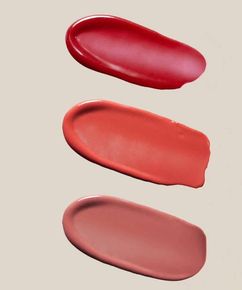 Color swatches of SU:M37 Skin-Stay Glossy Lip Balm in vibrant shades on a neutral background.