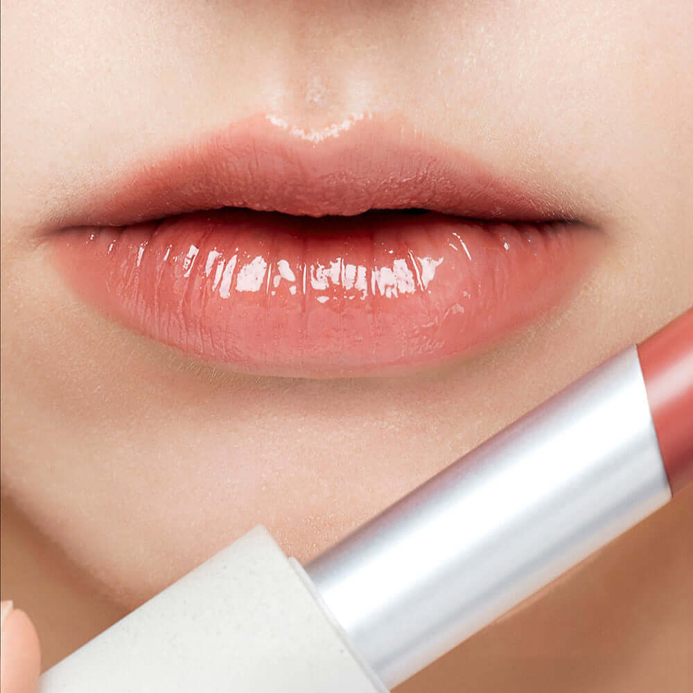 Close-up of lips wearing SU:M37 Skin-Stay Glossy Lip Balm for smooth, shiny finish.