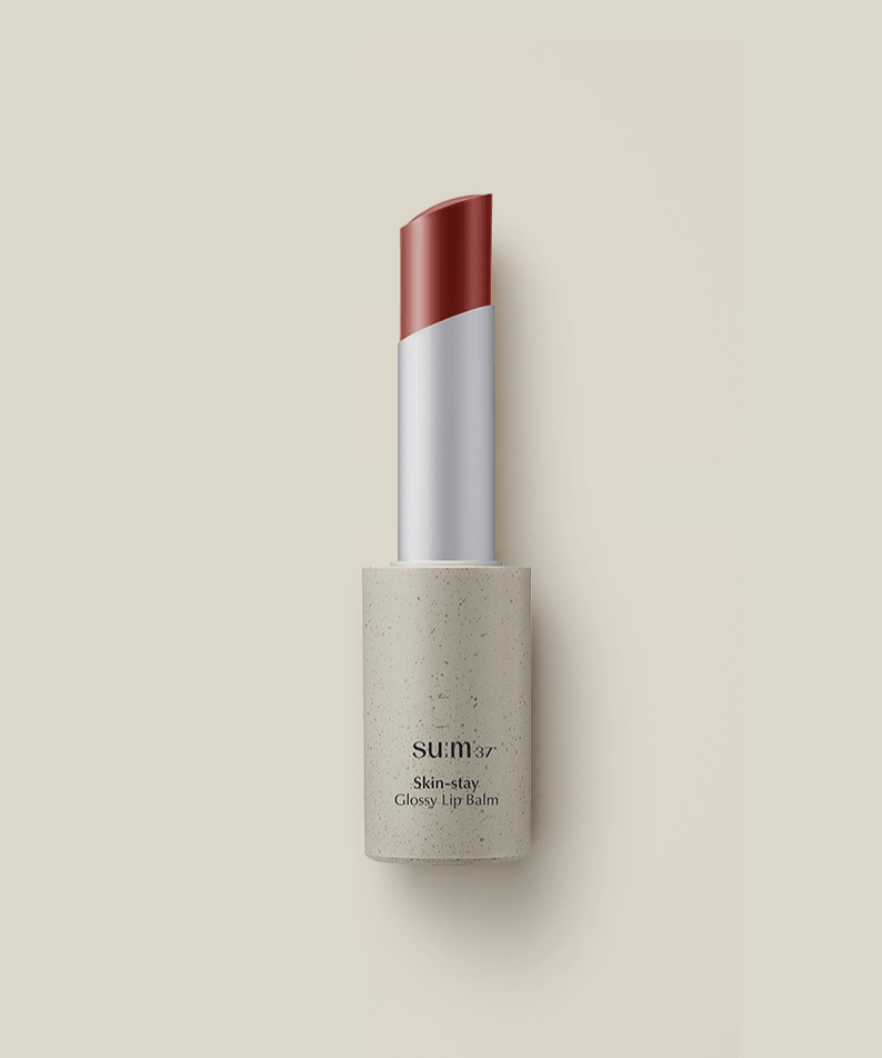 SU:M37 Skin-Stay Glossy Lip Balm in a sleek tube, offering a hydrating and shiny finish for lips.