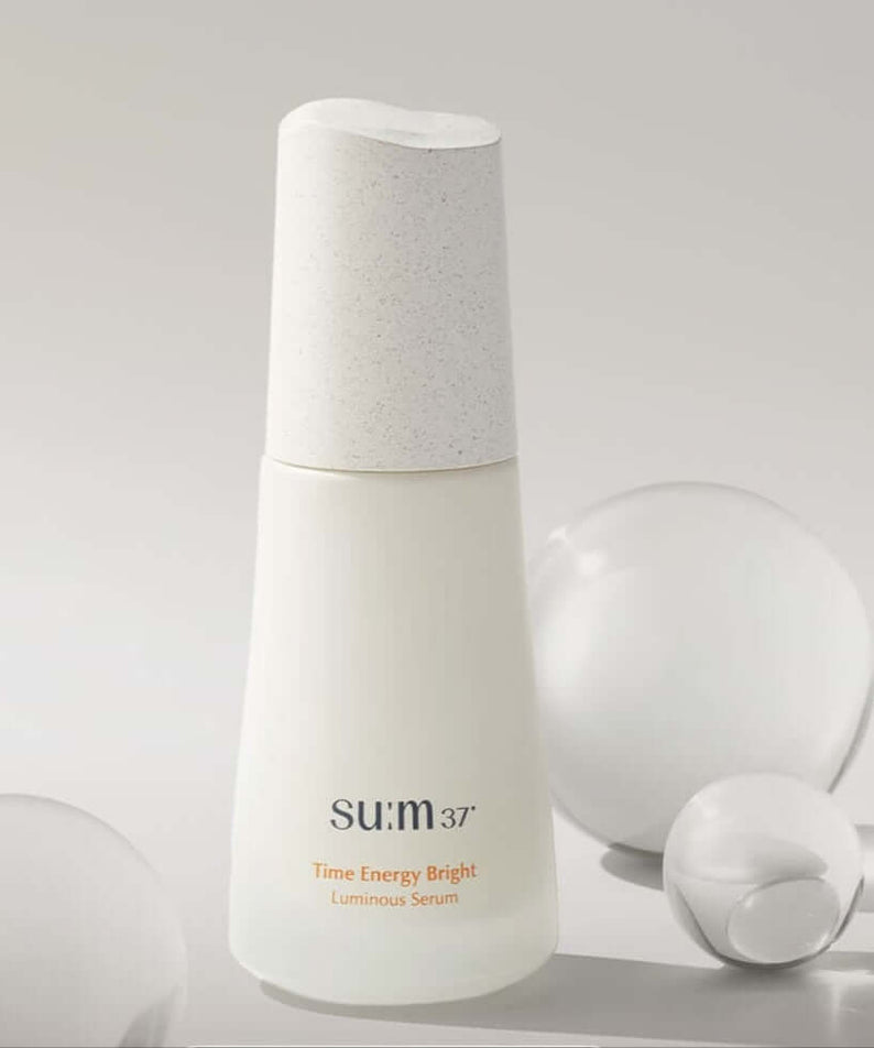 SU:M37 Time Energy Bright Luminous Serum 50ml displayed with decorative bubbles