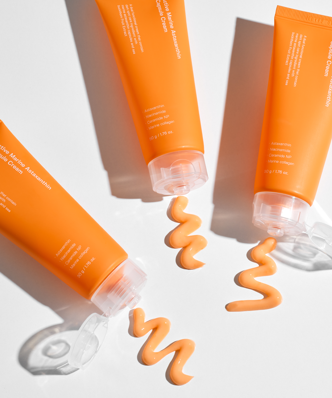 SUNGBOON EDITOR Active Marine Astaxanthin Capsule Cream 50g tubes on a white background with cream texture displayed