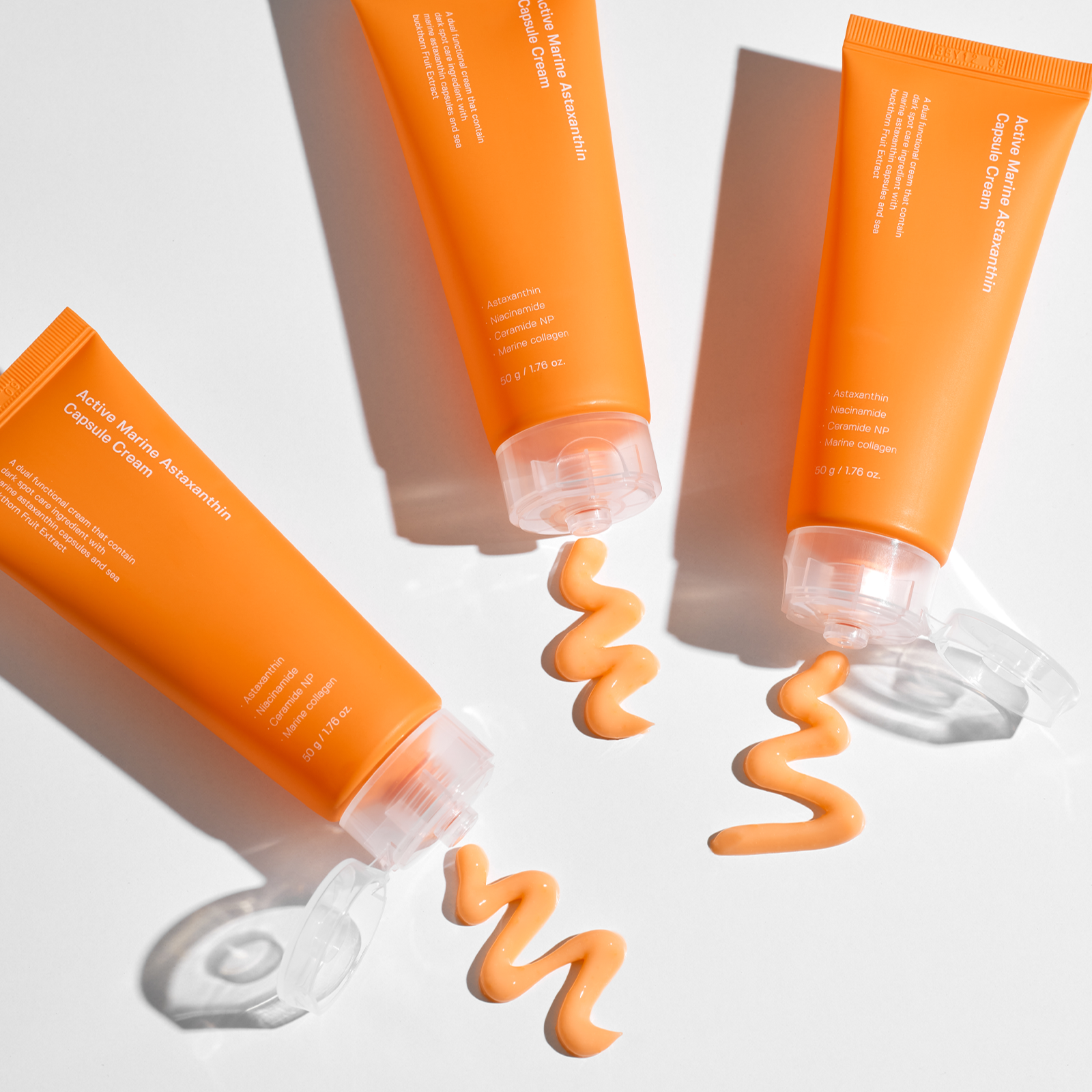 SUNGBOON EDITOR Active Marine Astaxanthin Capsule Cream 50g tubes on a white background with cream texture displayed
