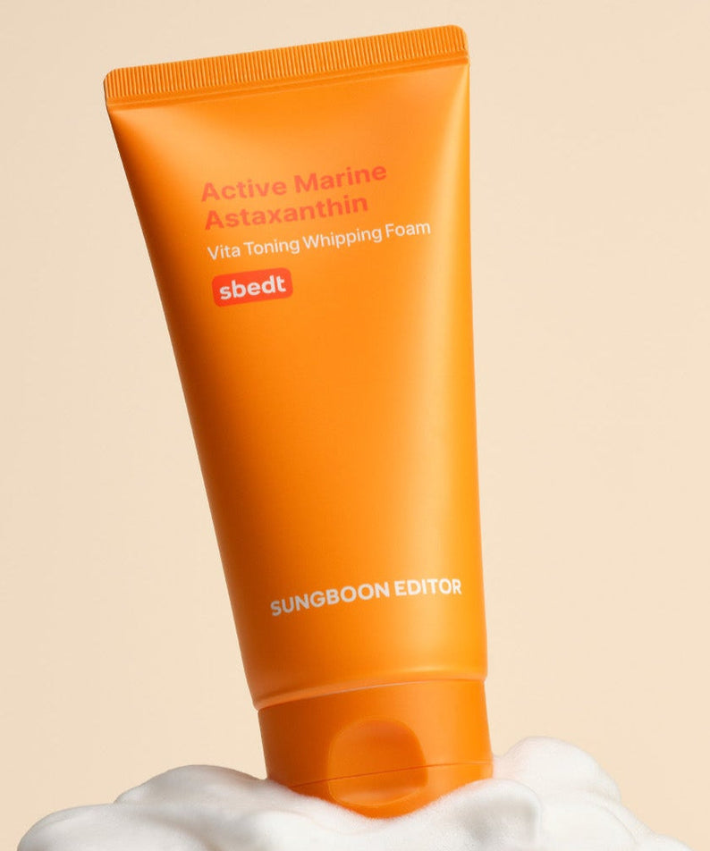 SUNGBOON EDITOR Active Marine Astaxanthin Vita Toning Whipping Foam 120g with orange tube on a foamy background