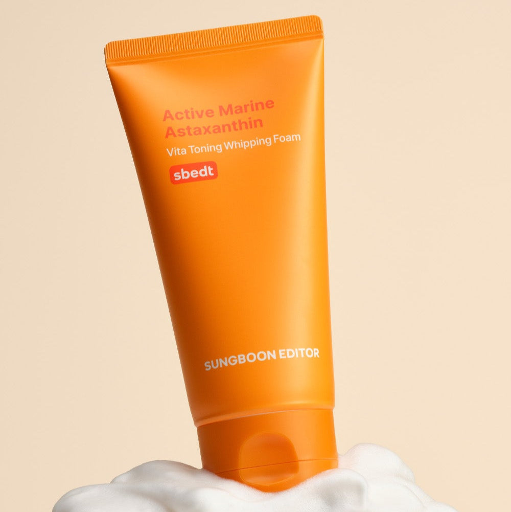 SUNGBOON EDITOR Active Marine Astaxanthin Vita Toning Whipping Foam 120g with orange tube on a foamy background