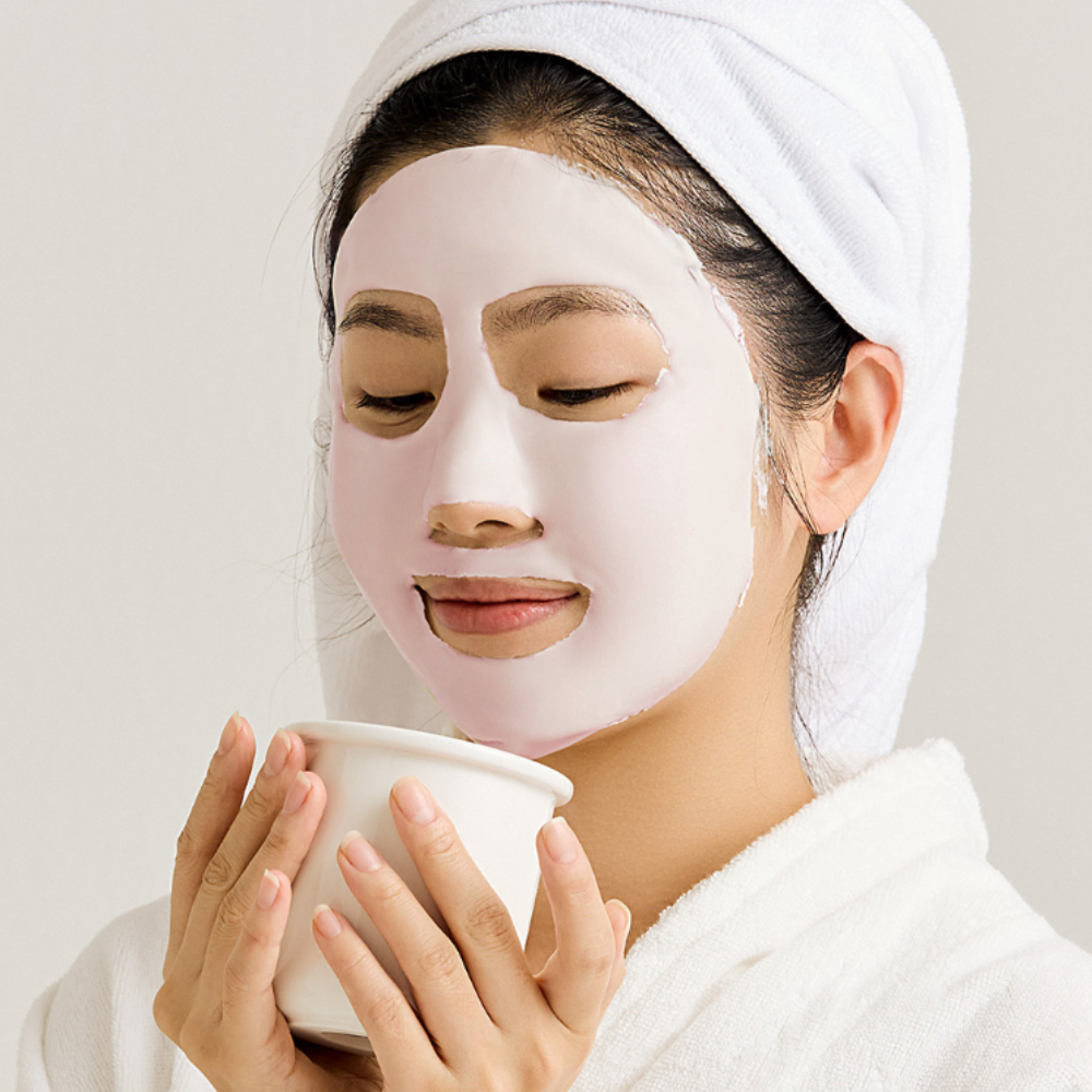 Woman applying SUNGBOON EDITOR Boosting Modeling Pack Apple Peel Glow Soothing for skincare routine