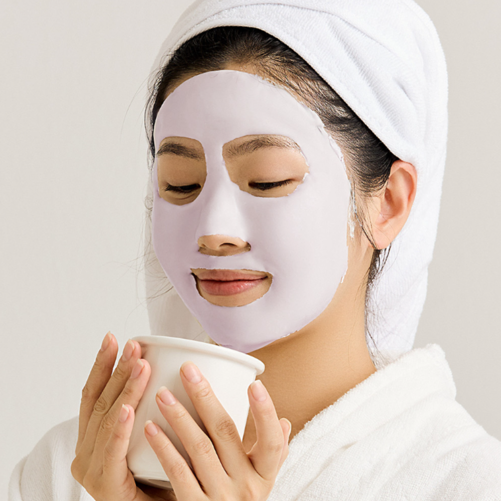 Woman enjoying relaxation with SUNGBOON EDITOR Boosting Modeling Pack Meoru Podo Brightening on face