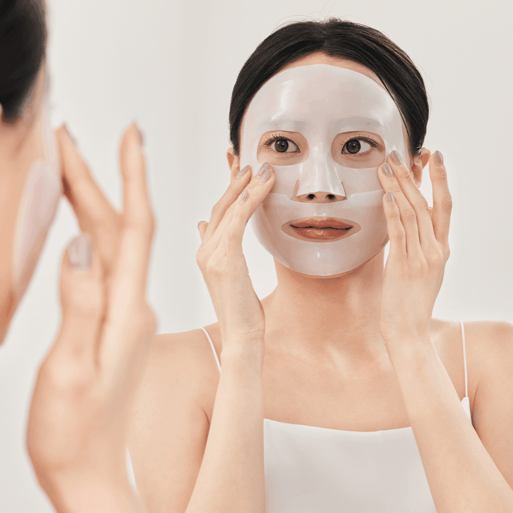 Woman applying SUNGBOON EDITOR Deep Collagen Anti Wrinkle Lifting Mask 37g for skin care.