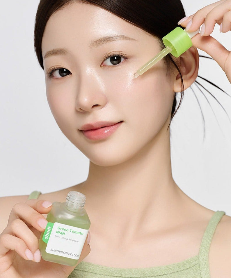 SUNGBOON EDITOR Green Tomato NMN Pore Lifting Ampoule 40ml being applied by a model using a dropper.