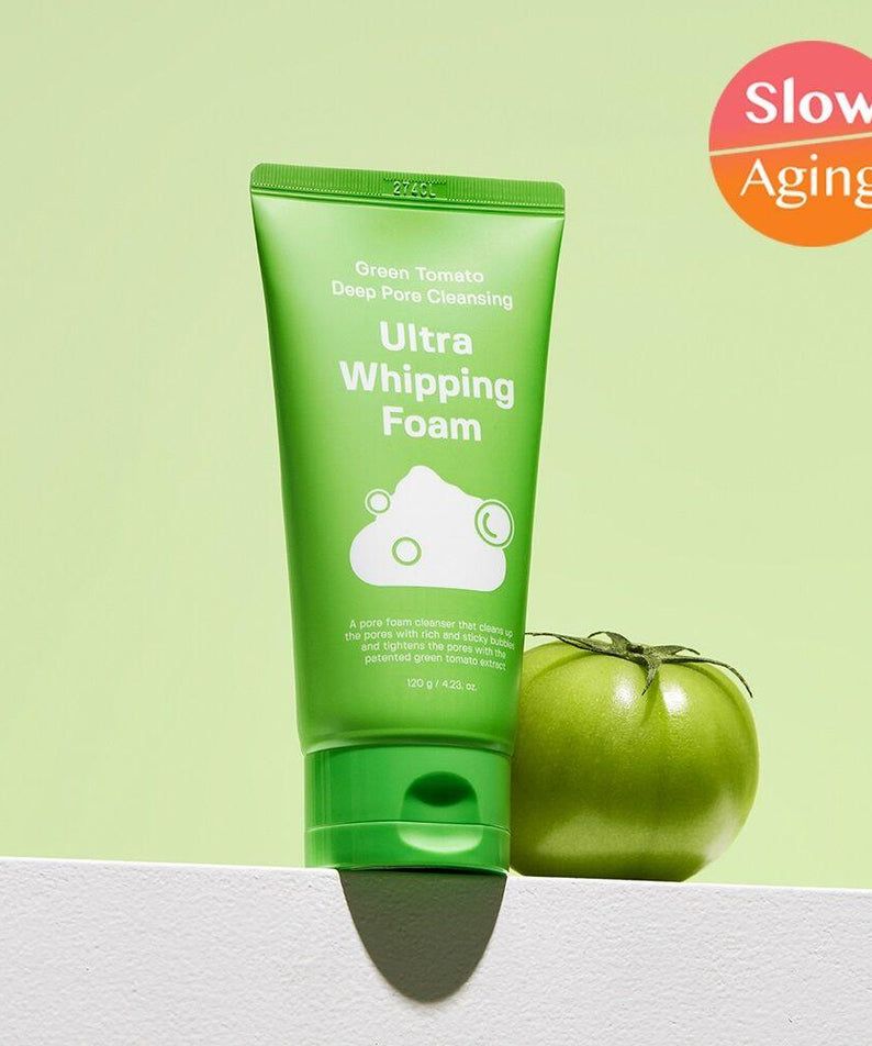 SUNGBOON EDITOR Green Tomato Pore Whipping Foam 120g with green packaging next to a fresh green tomato, highlighting "Slow Aging" benefits.