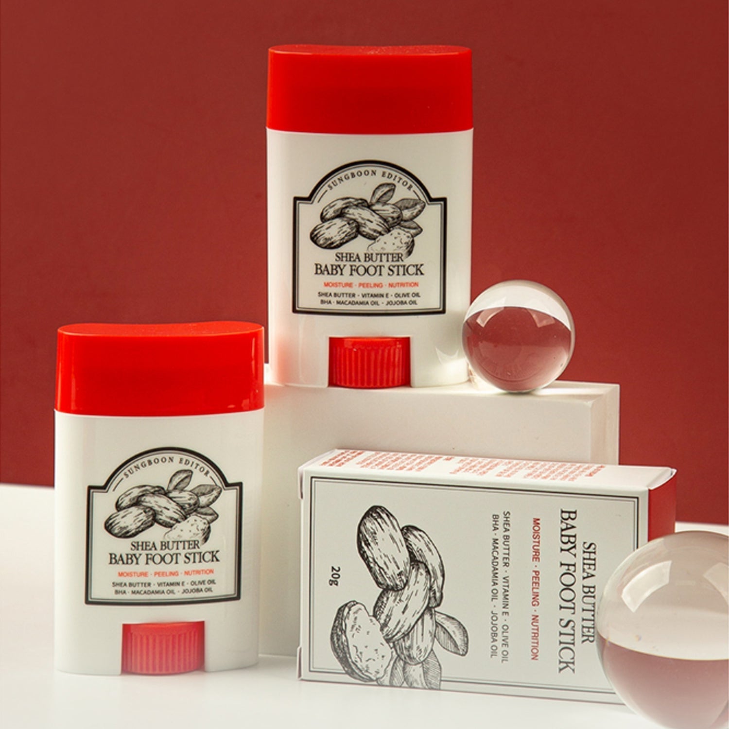 SUNGBOON EDITOR Shea Butter Baby Foot Stick displayed with packaging and decorative elements.