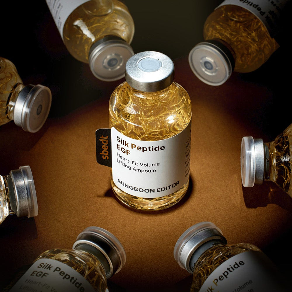 SUNGBOON EDITOR Silk Peptide EGF Heart-Fit Volume Lifting Ampoule 40ml bottles displayed artistically on a dark background.