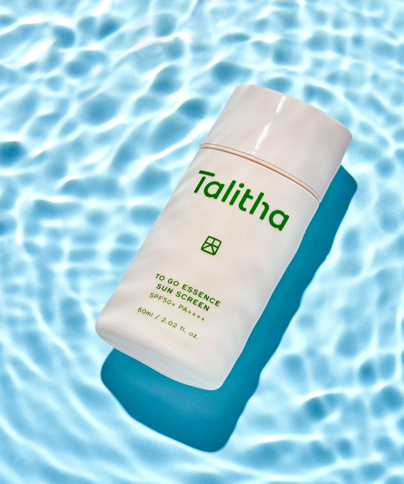 TALITHA KOUM To go Essence Sun Screen 60ml product image over a water pattern background