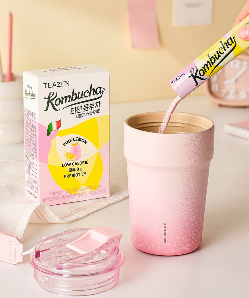 TEAZEN Kombucha Sicillian Pink Lemon 10 Sticks with pink cup and box on pastel background