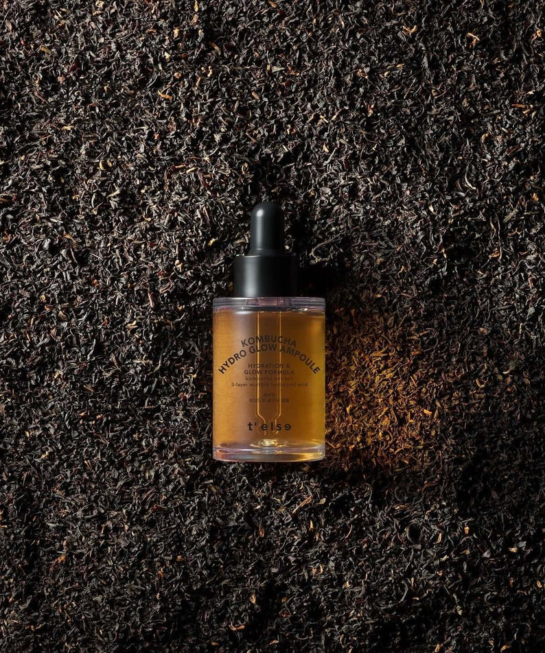 T'ELSE Kombucha Hydro Glow Ampoule 30ml bottle on tea leaves background