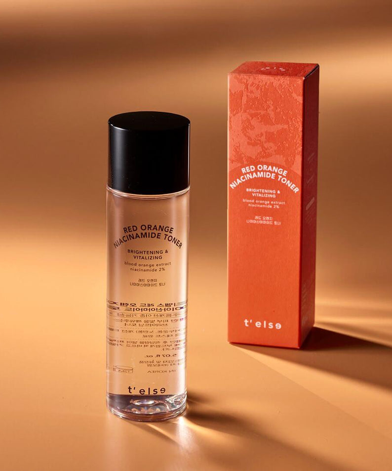 t'else Red Orange Niacinamide Toner with box on a gold background