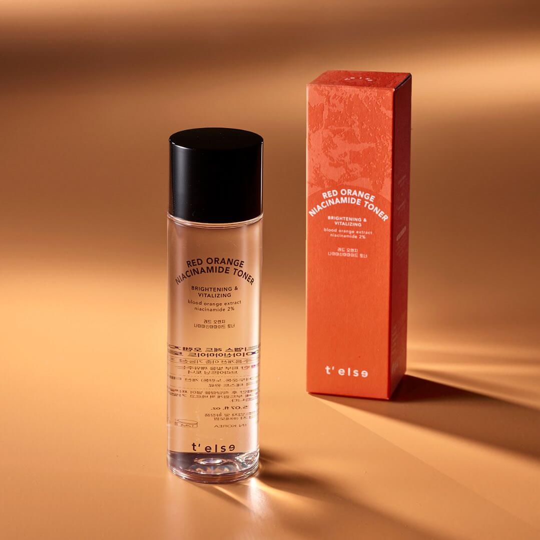 t'else Red Orange Niacinamide Toner with box on a gold background
