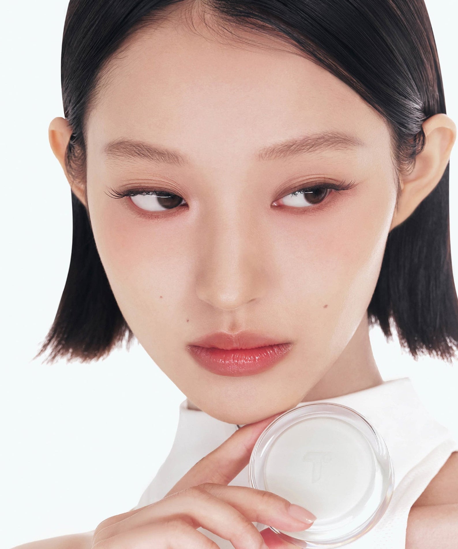Model holding TENSE Hybrid Makeup Saver, showcasing smooth skin effect