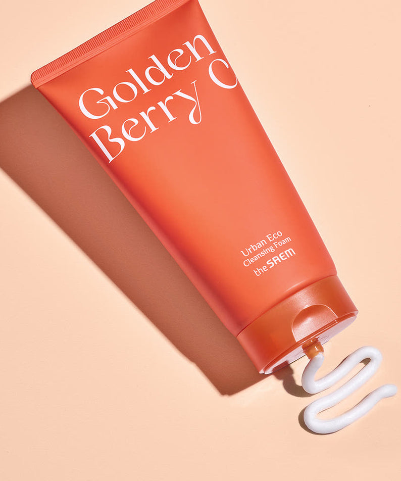 THE SAEM Urban Eco Golden Berry C Cleansing Foam 150ml on beige background with product dispensed