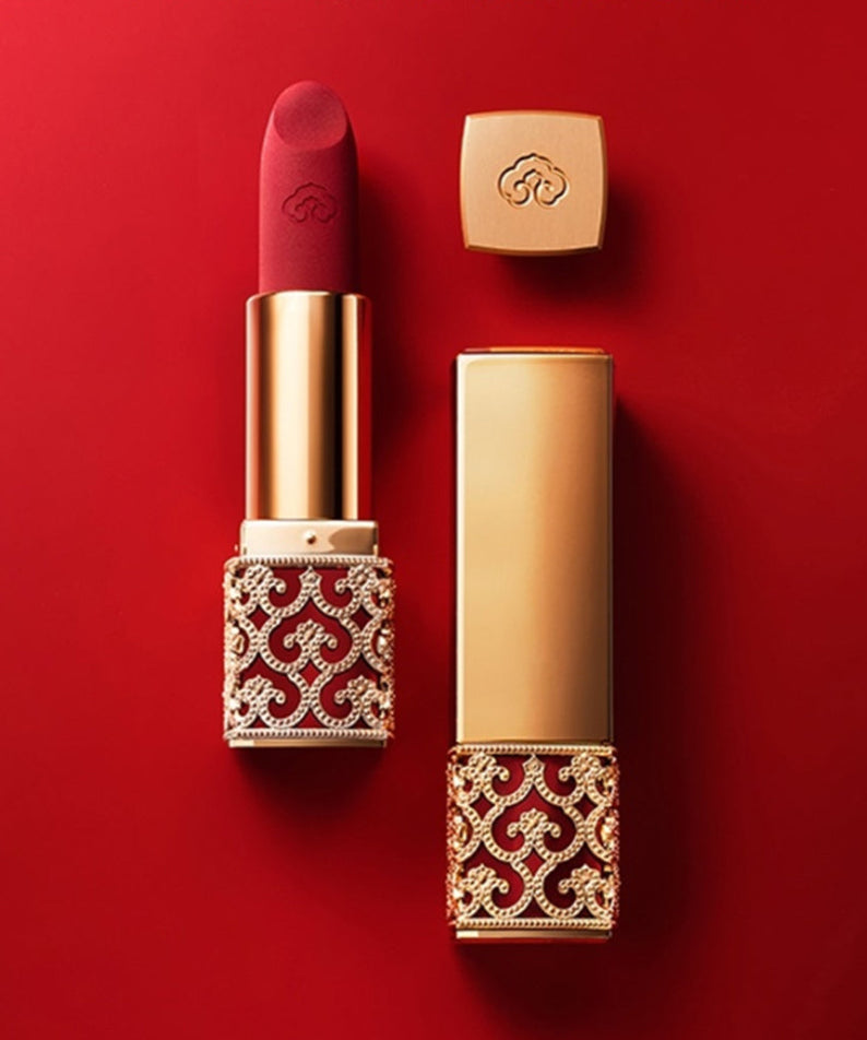 THE WHOO Gong Jin Hyang Mi Velvet Lip Rouge luxury lipstick in elegant red and gold packaging on red background.