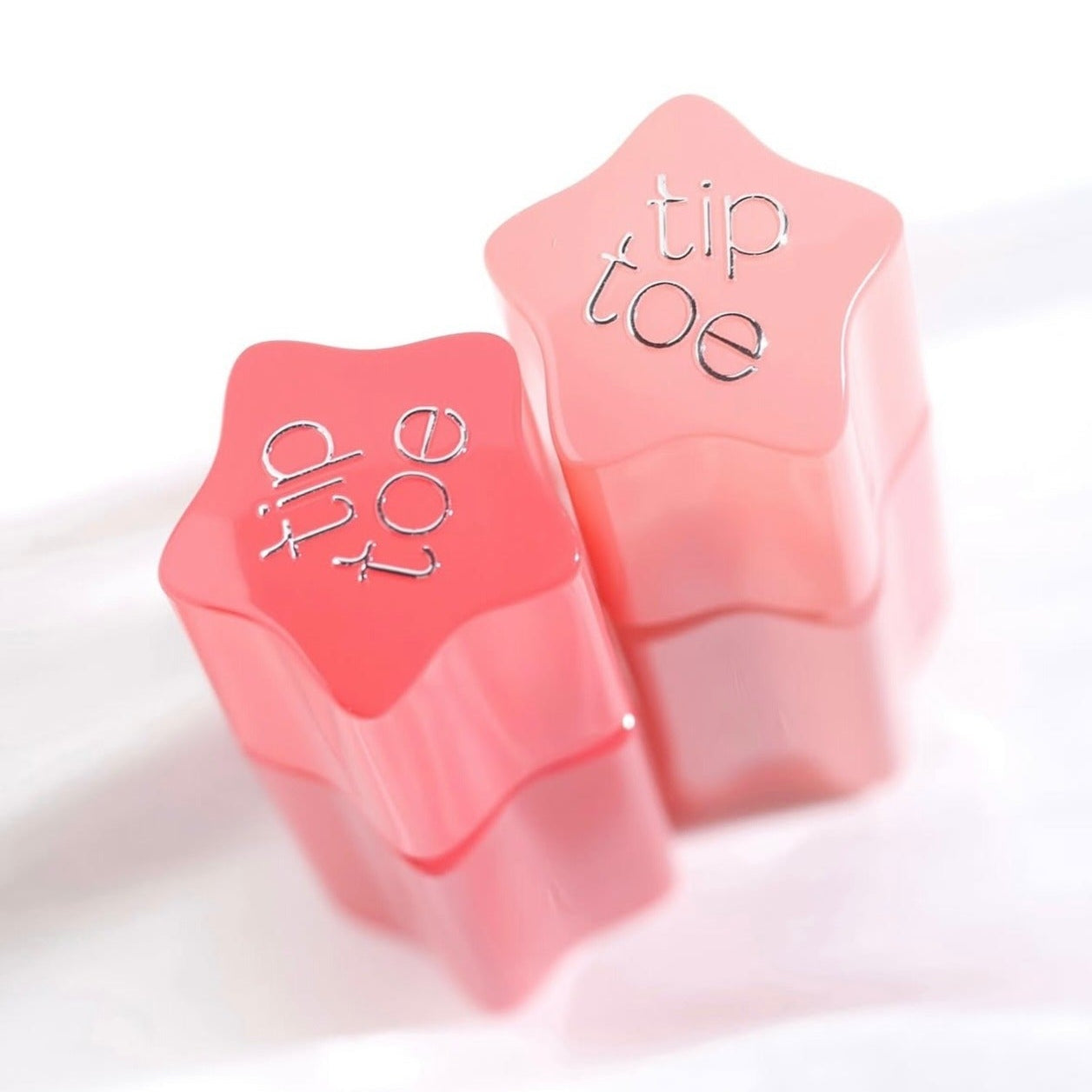 TIP TOE Glowit Sorbet Tint in star-shaped containers, showcasing the vibrant lip tint product.