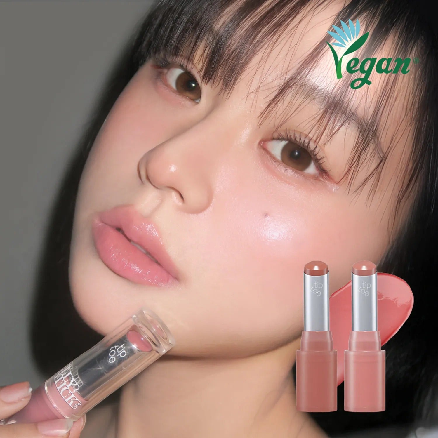 Woman applying TIP TOE Jelly Stick Plan vegan lip product showcasing natural glow and beauty.