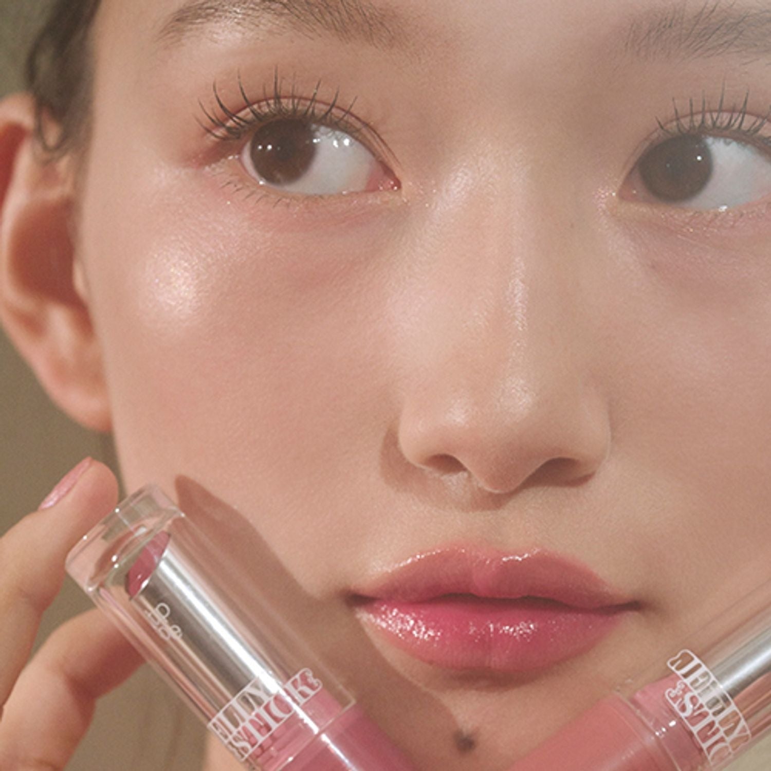 Close-up of a model showcasing TIP TOE Jelly Stick Plan with radiant, glossy lips and clear complexion.