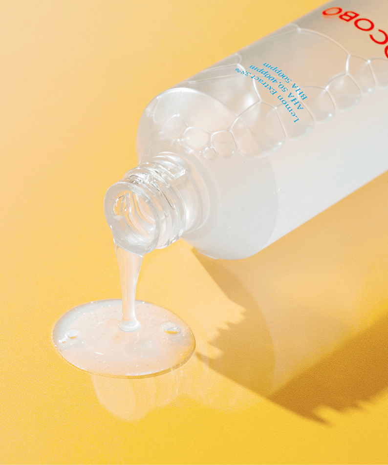 TOCOBO AHA BHA Lemon Toner bottle pouring liquid on yellow background