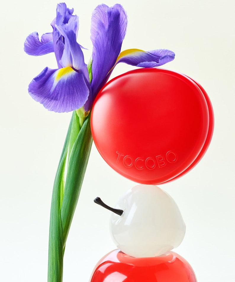 Image of TOCOBO Apple Dewy Fit Cushion with a purple iris flower.