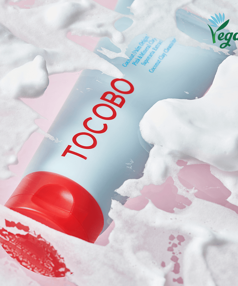 TOCOBO Coconut Clay Cleansing Foam with vegan label, creamy texture and bubbles on pink surface