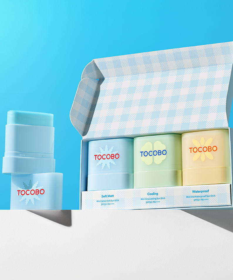 TOCOBO Mini Sun Stick Trio, a set of sun protection sticks displayed with open box against a blue background, SPF 50+ protection.