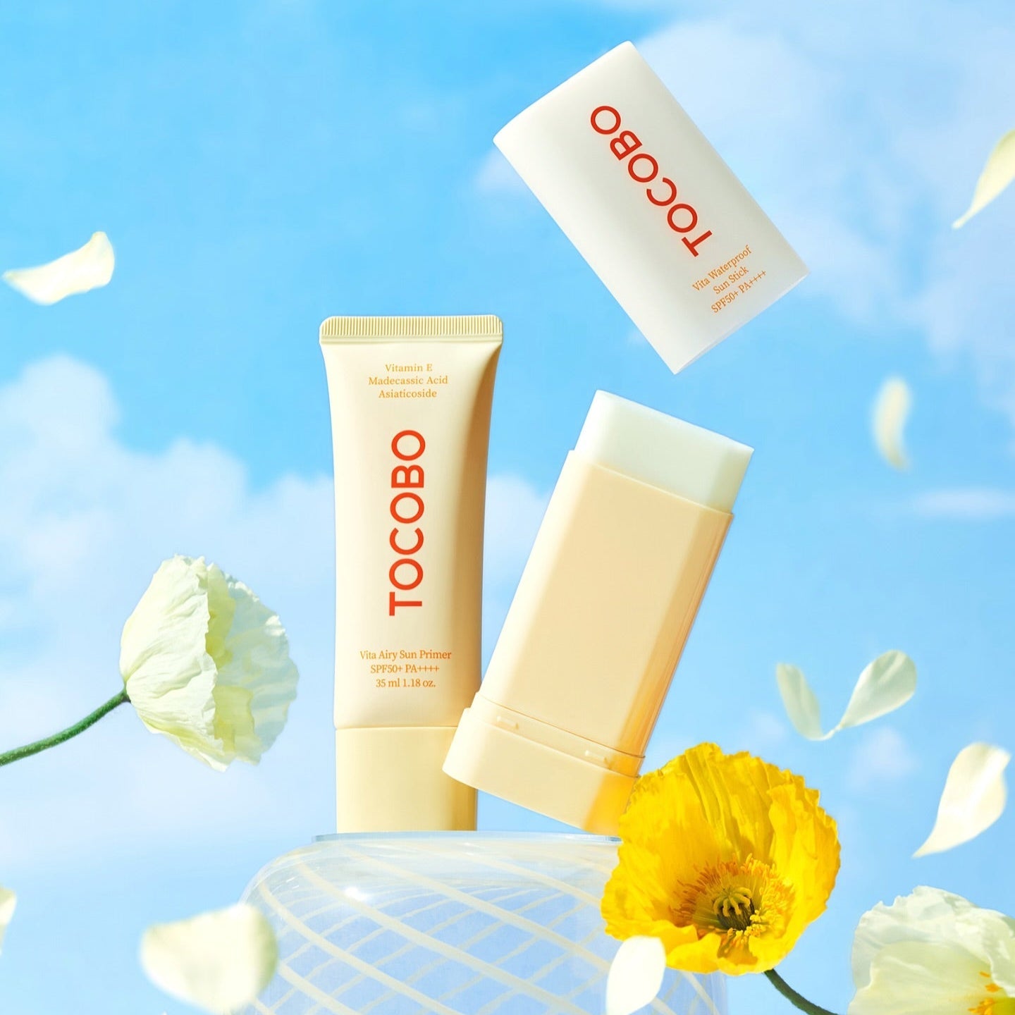 TOCOBO Vita Airy Sun Primer 35ml shown with bright flowers against a blue sky background.