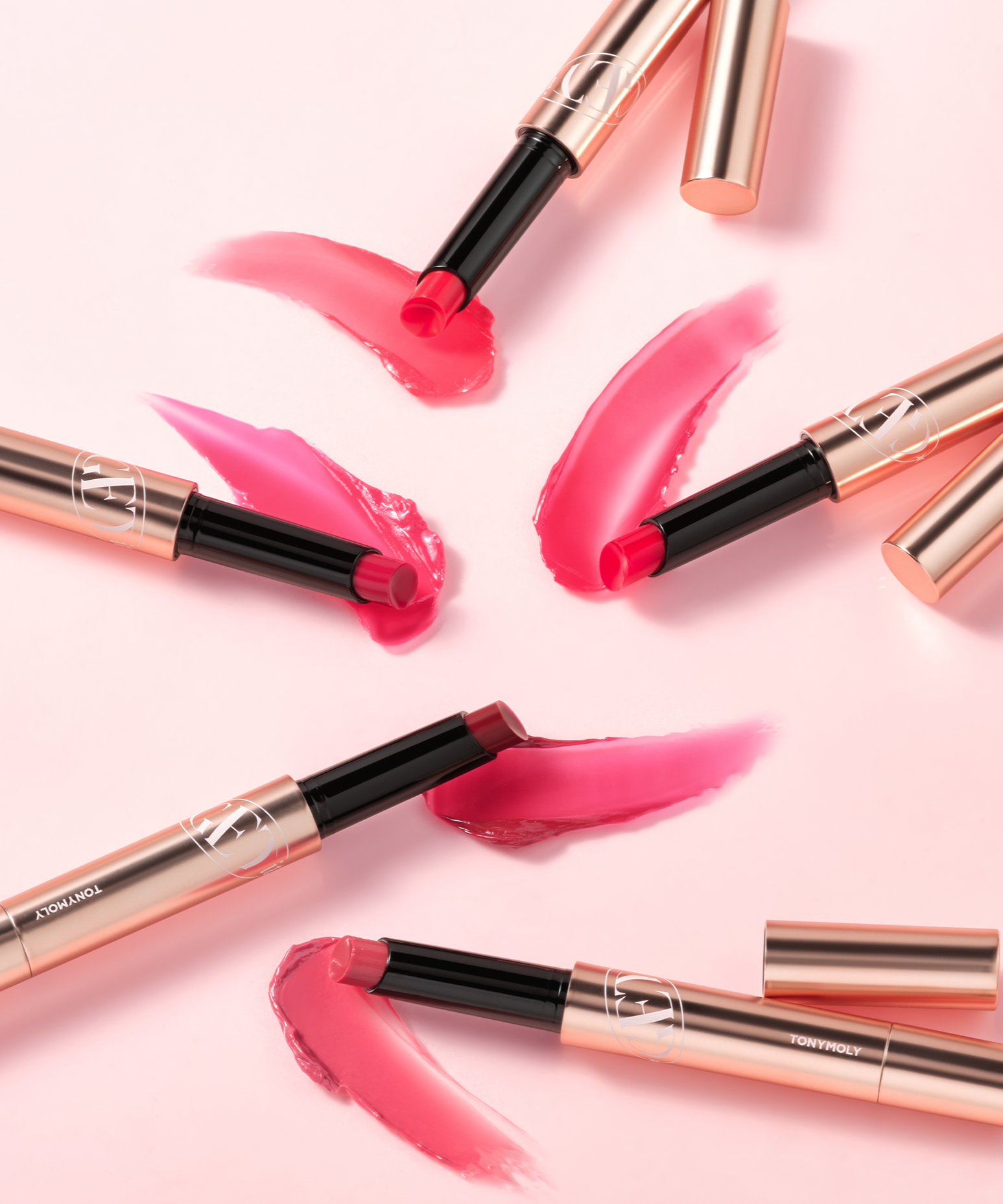 TONY MOLY Get It Tint Glaze Balm in various shades on pink background
