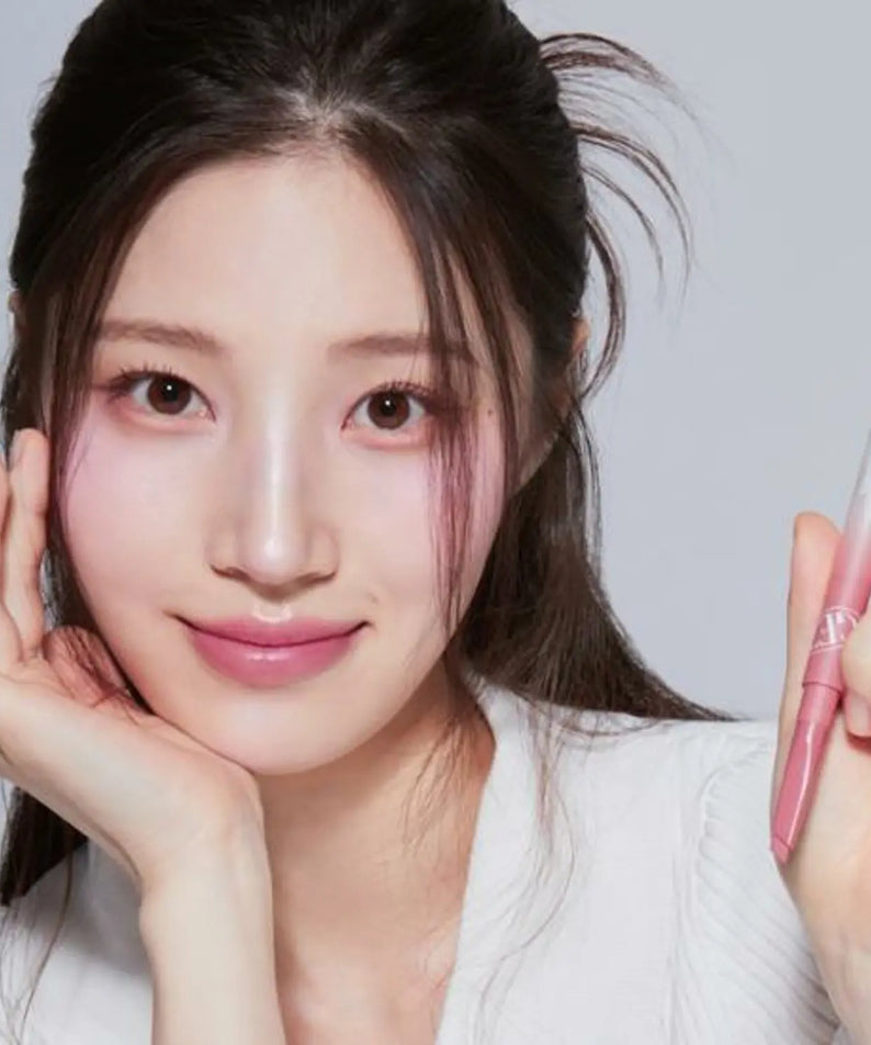 Woman holding TONY MOLY Get It Tint Lip Liner, showcasing the makeup product with a soft smile.