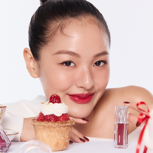 Model with TONY MOLY Get It Tint Waterful Butter lip tint, smiling with dessert, product shown beside for vibrant, long-lasting color appeal.