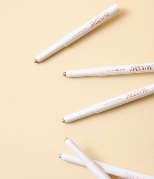 TONY MOLY The Shocking Color Fixing Stick Shadow makeup pencils on beige background