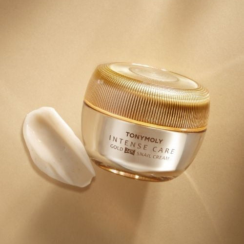 Product image of TONYMOLY Intense Care Gold24K Snail Cream 45ml with gold packaging on a beige background.
