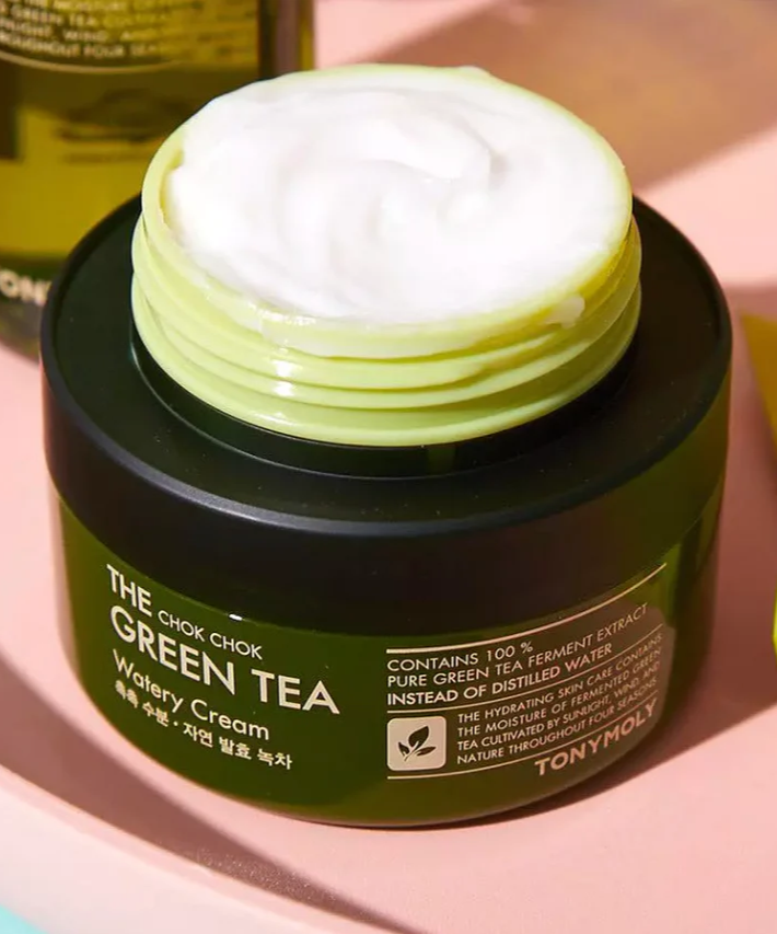 TONYMOLY More Moist Green Tea Gel Cream 60ml in an open jar on a pink surface with a green background.