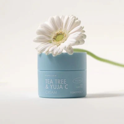 TONYMOLY Pure Dew Tea Tree & Yuja C Cream 50ml with a flower, moisturizing and soothing skincare product in blue jar.
