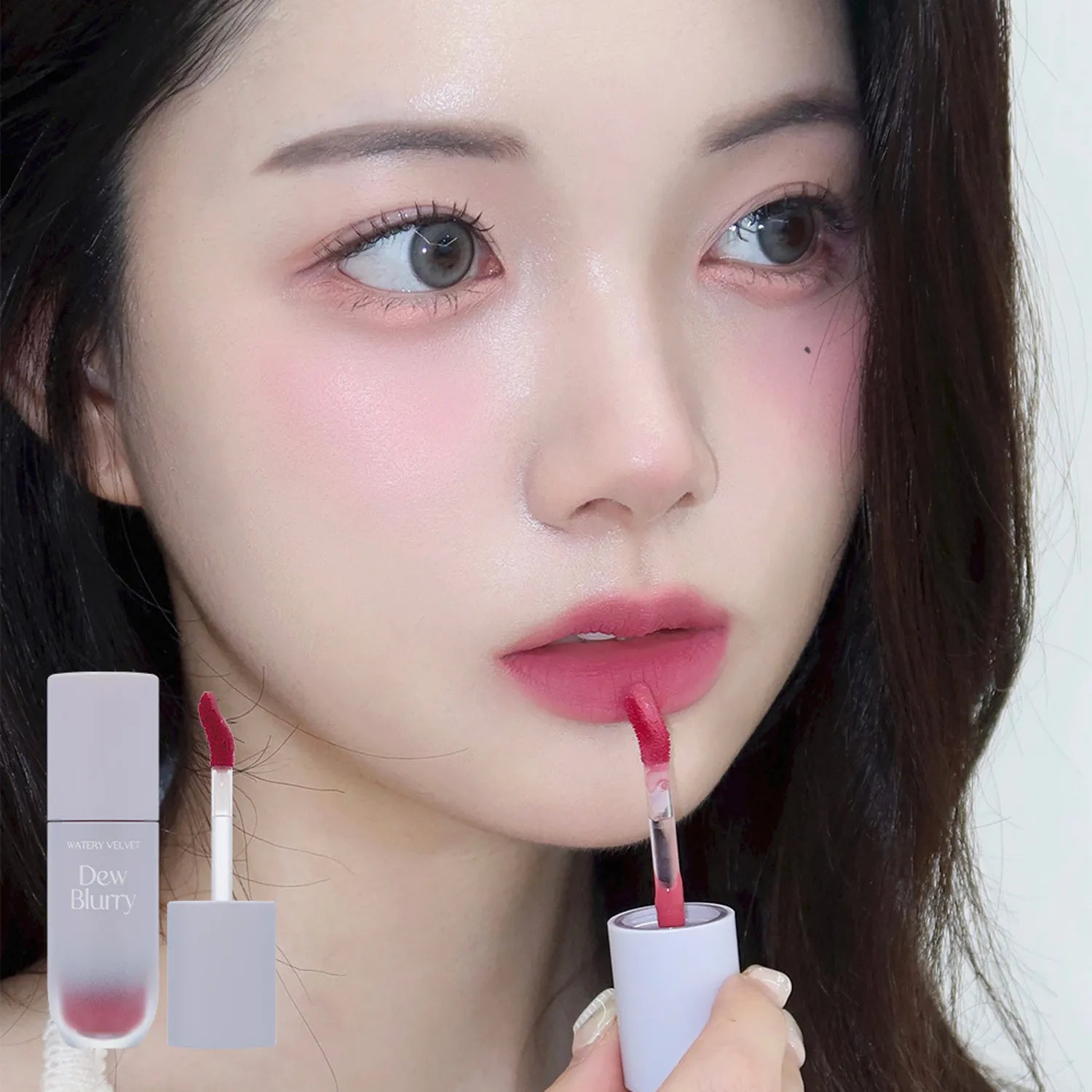TOO COOL FOR SCHOOL Dew Blurry Tint applied on model's lips with product packaging in view.