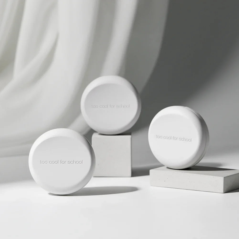 TOO COOL FOR SCHOOL Fixing Cover Cushion (Main Product + Refill) displayed on white pedestal for cosmetic presentation.