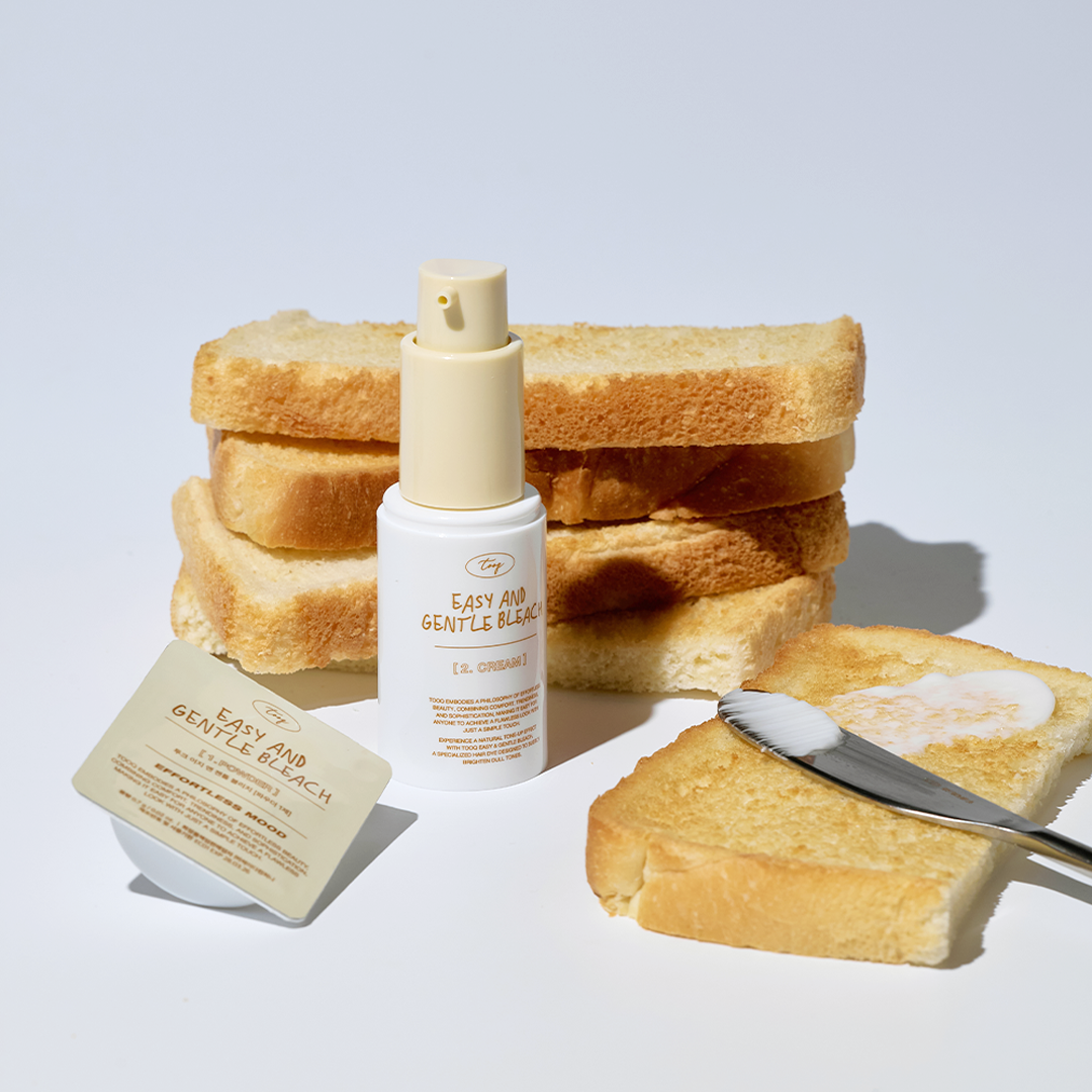 TOOQ Easy And Gentle Bleach bottle surrounded by toast and a brush on a white background.