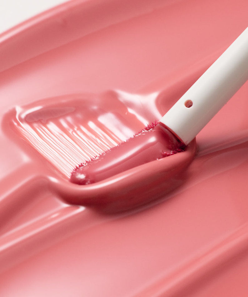 TOOQ Gentle Kiss Glow Tint swatched with applicator for a smooth pink finish