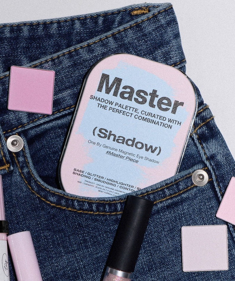 TOOQ Master Piece Face Shadow Palette nestled in denim with makeup accessories and pink eyeshadow squares.